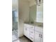 Bright bathroom featuring double sink vanity, quartz countertops and framed glass shower at 8793 Candelabra Ct, Las Vegas, NV 89148