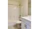 White bathroom with a bathtub, toilet, sink, and a white tiled floor at 8793 Candelabra Ct, Las Vegas, NV 89148