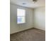 This bedroom features neutral walls and carpeting plus a window at 8793 Candelabra Ct, Las Vegas, NV 89148