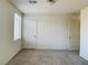 Neutral bedroom with carpeted floor, window, and two doors at 8793 Candelabra Ct, Las Vegas, NV 89148
