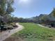 A walking path curves through a manicured green space in the community at 8793 Candelabra Ct, Las Vegas, NV 89148