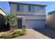 Charming two-story home with a two-car garage, stone accents, and a well-maintained front yard at 8793 Candelabra Ct, Las Vegas, NV 89148
