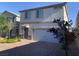 Charming two-story home with a two-car garage, stone accents, and a well-maintained front yard at 8793 Candelabra Ct, Las Vegas, NV 89148