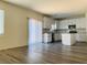 Bright kitchen featuring white cabinets, stainless steel appliances and wood look floors at 8793 Candelabra Ct, Las Vegas, NV 89148
