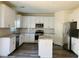 Modern kitchen with white cabinets, stainless steel appliances, and an island at 8793 Candelabra Ct, Las Vegas, NV 89148