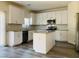 Eat in kitchen featuring white cabinets and wood look floors at 8793 Candelabra Ct, Las Vegas, NV 89148