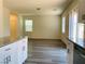 Open-concept kitchen and living area with stainless steel appliances and wood-look flooring at 8793 Candelabra Ct, Las Vegas, NV 89148