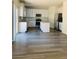 Spacious kitchen with white cabinets, stainless appliances, gray counters, and wood-look flooring at 8793 Candelabra Ct, Las Vegas, NV 89148