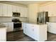 Modern kitchen features stainless steel appliances, gray countertops, and white cabinets with an island at 8793 Candelabra Ct, Las Vegas, NV 89148