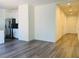 Open-concept living space with durable wood-look flooring adjacent to kitchen and hallway at 8793 Candelabra Ct, Las Vegas, NV 89148