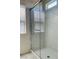 Clear glass shower with marble style walls and chrome hardware at 8793 Candelabra Ct, Las Vegas, NV 89148