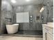 Modern bathroom showcasing a luxurious soaking tub and a frameless glass shower at 8931 Lansberry Ct, Las Vegas, NV 89147