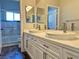 Bright bathroom featuring a double vanity with white countertops and modern faucets at 8931 Lansberry Ct, Las Vegas, NV 89147