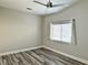 Bedroom featuring sleek, modern flooring, a ceiling fan, and a bright window at 8931 Lansberry Ct, Las Vegas, NV 89147