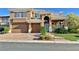 Charming two-story home boasts a three-car garage and meticulously landscaped front yard at 8931 Lansberry Ct, Las Vegas, NV 89147