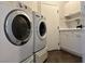 Well-equipped laundry room featuring modern appliances and ample storage space at 8931 Lansberry Ct, Las Vegas, NV 89147