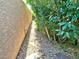 Narrow side yard with stone walkway and well-maintained greenery along a stucco wall at 8931 Lansberry Ct, Las Vegas, NV 89147