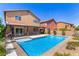 A sparkling in-ground pool and covered patio make this backyard perfect for relaxing and entertaining at 9173 Weeping Hollow Ave, Las Vegas, NV 89178