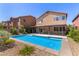 The sparkling in-ground pool and patio create a backyard oasis at 9173 Weeping Hollow Ave, Las Vegas, NV 89178
