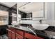 Bathroom with black marble backsplash, double sinks, and modern lighting at 9173 Weeping Hollow Ave, Las Vegas, NV 89178