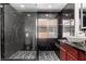 Modern bathroom boasts an elegant glass shower and dark marble-style tiling throughout at 9173 Weeping Hollow Ave, Las Vegas, NV 89178