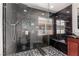 Sleek bathroom featuring a glass shower with black marble tile and mosaic floors at 9173 Weeping Hollow Ave, Las Vegas, NV 89178
