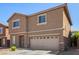 Two-story home with desert landscaping, two car garage, and neutral colored stucco at 9173 Weeping Hollow Ave, Las Vegas, NV 89178