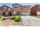 Two-story home featuring desert landscaping and an attached two-car garage at 9173 Weeping Hollow Ave, Las Vegas, NV 89178