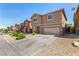 Two-story home with desert landscaping and an attached two-car garage at 9173 Weeping Hollow Ave, Las Vegas, NV 89178