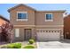 Exterior shot of two-story home with desert landscaping and neutral colored stucco at 9173 Weeping Hollow Ave, Las Vegas, NV 89178