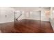 Bright living room with hardwood floors and a white staircase at 9173 Weeping Hollow Ave, Las Vegas, NV 89178