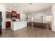 Open-concept living room and kitchen with hardwood floors and an island with seating at 9173 Weeping Hollow Ave, Las Vegas, NV 89178
