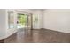Inviting living area with hardwood floors and sliding door to a backyard pool at 9173 Weeping Hollow Ave, Las Vegas, NV 89178