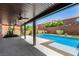 Covered patio includes ceiling fans and overlooks a private backyard with a sparkling pool at 9173 Weeping Hollow Ave, Las Vegas, NV 89178