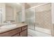 This bathroom features granite counters, patterned tile, and a shower/tub combo at 9305 Hollycrest Dr, Las Vegas, NV 89117