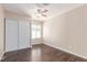Cozy bedroom featuring wood flooring, sliding closet doors and a ceiling fan at 9305 Hollycrest Dr, Las Vegas, NV 89117