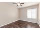 Bedroom with a ceiling fan, wood-look flooring, and a window at 9305 Hollycrest Dr, Las Vegas, NV 89117