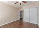 Bedroom with a ceiling fan, wood-look flooring and a door into the bathroom at 9305 Hollycrest Dr, Las Vegas, NV 89117