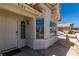 Charming home featuring a white front door, stucco siding, and large windows, creating an inviting and well-lit entry at 9305 Hollycrest Dr, Las Vegas, NV 89117