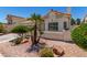 Landscaped single-story home featuring a tiled roof and well-maintained grounds at 9305 Hollycrest Dr, Las Vegas, NV 89117