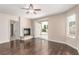 Living room with fireplace, ceiling fan, sliding glass doors and wood flooring at 9305 Hollycrest Dr, Las Vegas, NV 89117