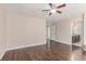Spacious main bedroom with wood flooring and a ceiling fan, leading into the main bathroom at 9305 Hollycrest Dr, Las Vegas, NV 89117