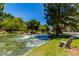 Picturesque pond with mature trees, waterscapes, and well-maintained grassy banks, offering a peaceful outdoor setting at 9305 Hollycrest Dr, Las Vegas, NV 89117