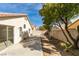 Spacious backyard featuring a covered patio, a retaining wall, and mature trees offering plenty of shade at 9378 Spellman Ct, Las Vegas, NV 89123