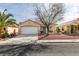 Charming single-story home featuring a well-maintained yard, two-car garage, and desert landscaping at 9378 Spellman Ct, Las Vegas, NV 89123