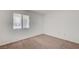 A sunlit bedroom with neutral carpeting, with a large window at 950 Seven Hills Dr # 1624, Henderson, NV 89052