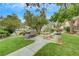 Outdoor barbecue and picnic area with lush green grass and mature trees at 950 Seven Hills Dr # 1624, Henderson, NV 89052