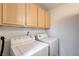 Convenient laundry room equipped with a washing machine, dryer, and overhead cabinets at 950 Seven Hills Dr # 1624, Henderson, NV 89052