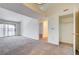 Open living area with carpet floors, a sliding glass door, and access to other rooms at 950 Seven Hills Dr # 1624, Henderson, NV 89052