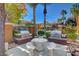 Community outdoor grilling area features two grills, a table, and seating, surrounded by palm trees and blue skies at 950 Seven Hills Dr # 1624, Henderson, NV 89052